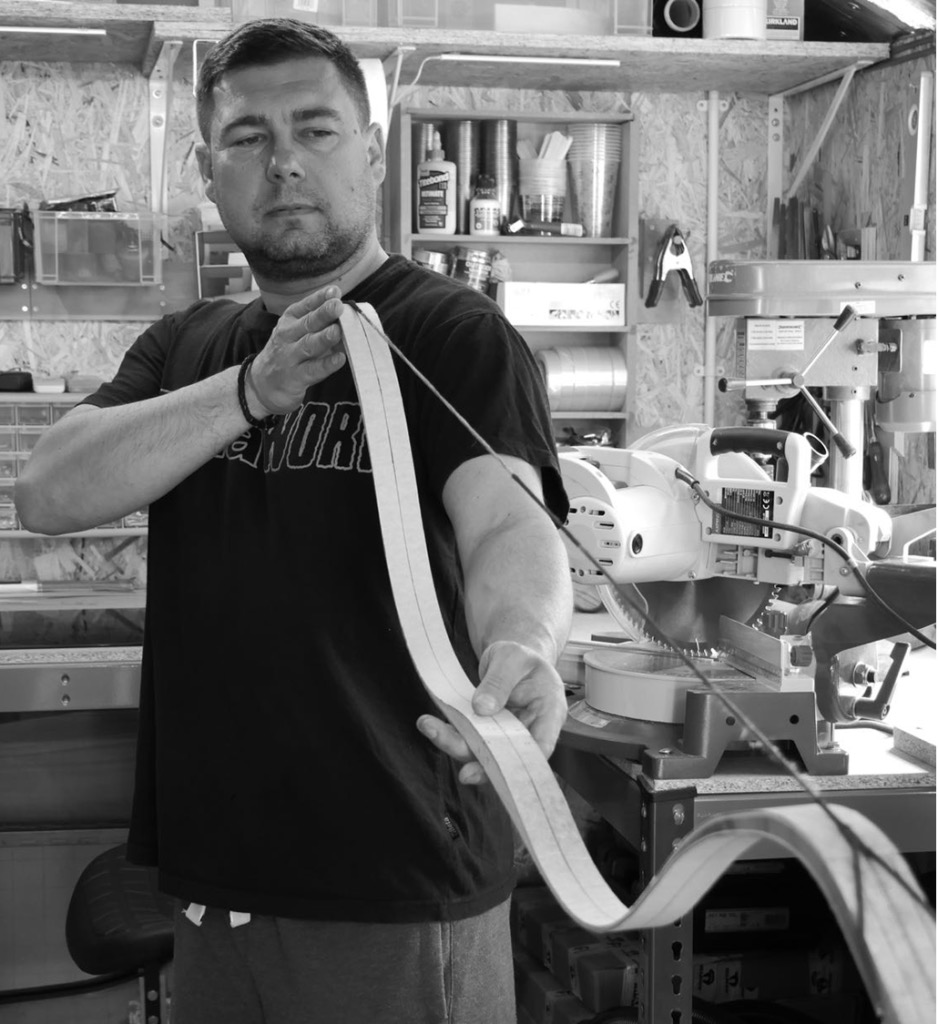 Robert Pozderka checking a bow limb in his Manchester workshop